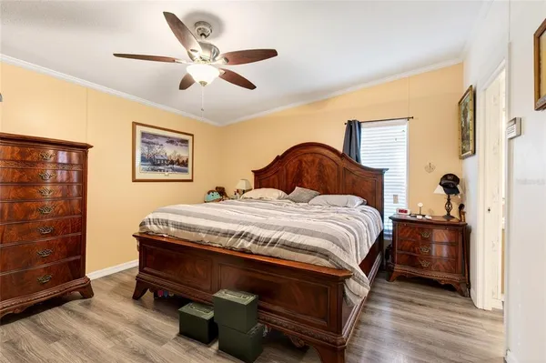 a spacious bedroom with a bed and a dresser