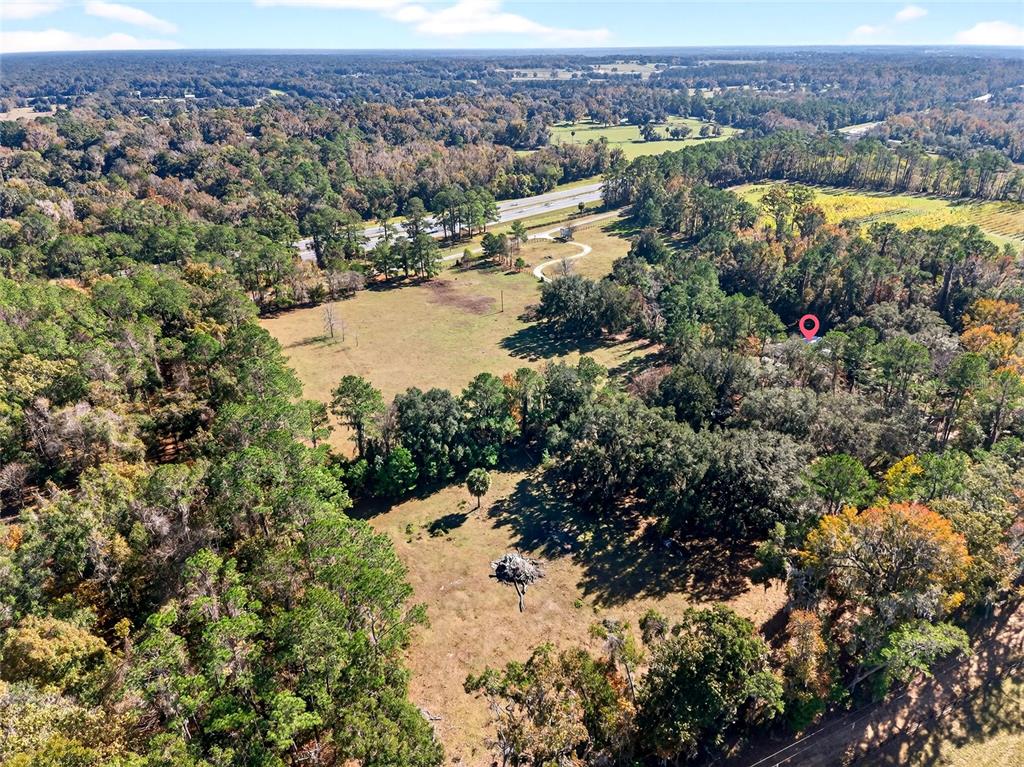 15340 Northwest 65th Avenue Road Reddick, FL 32686 - Photo 38 of 45 an aerial view of residential house with outdoor space and lake view