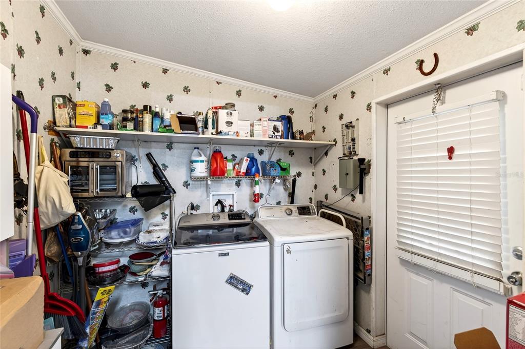 15340 Northwest 65th Avenue Road Reddick, FL 32686 - Photo 5 of 45 a storage room with washer and dryer