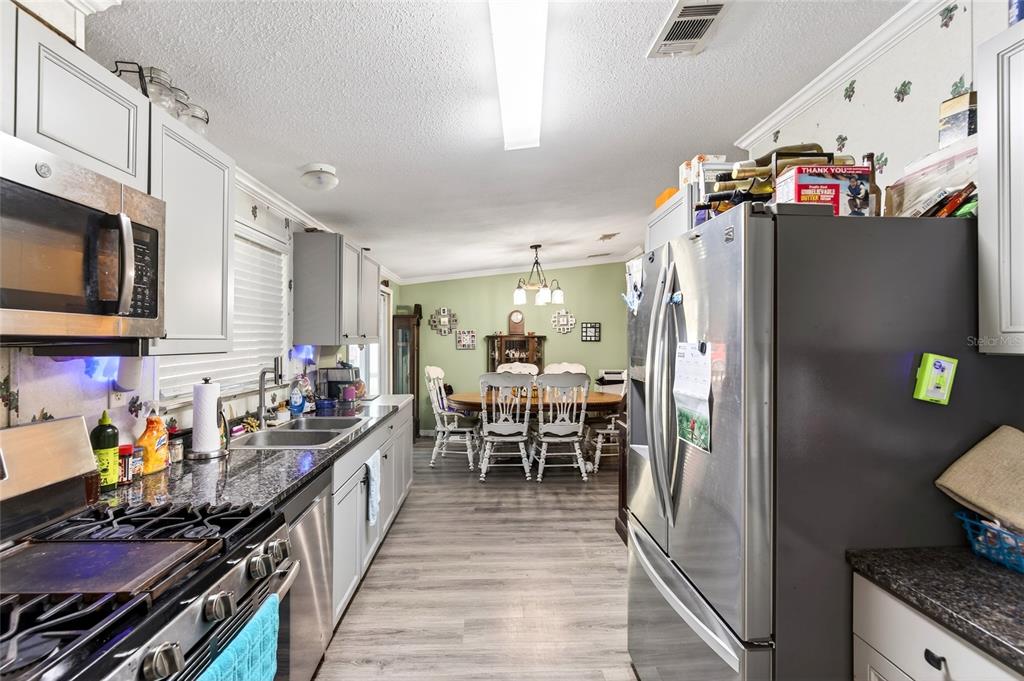 15340 Northwest 65th Avenue Road Reddick, FL 32686 - Photo 6 of 45 a kitchen with stainless steel appliances granite countertop a refrigerator and a dining table
