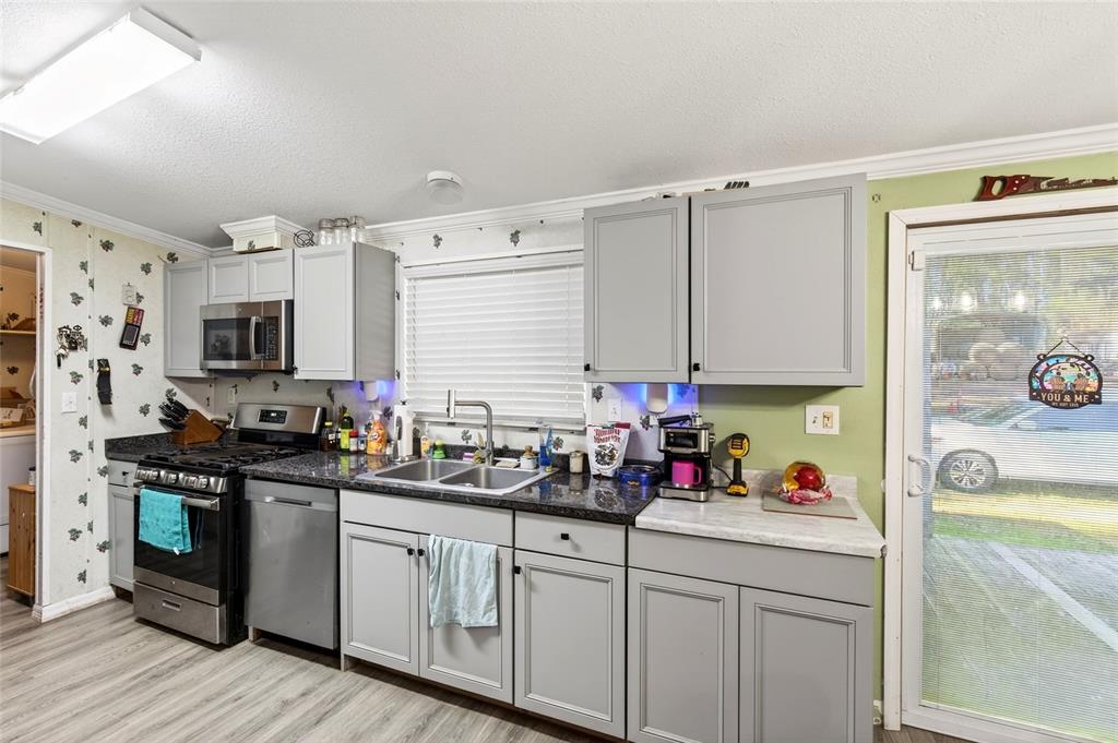 15340 Northwest 65th Avenue Road Reddick, FL 32686 - Photo 8 of 45 a kitchen with stainless steel appliances granite countertop a sink stove and refrigerator