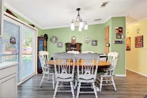 a view of a dining room with furniture wooden floor and chandelier
