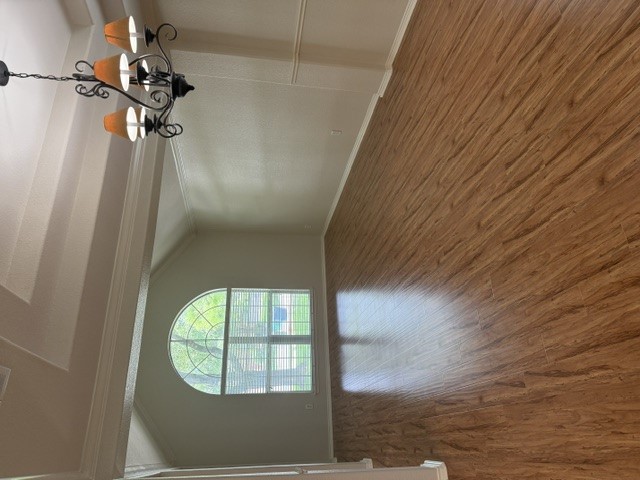 20724 Kearney Hill Road Pflugerville, TX 78660 - Photo 8 of 40 Spacious room featuring wood-finish flooring, a tray ceiling, and an arched window with blinds