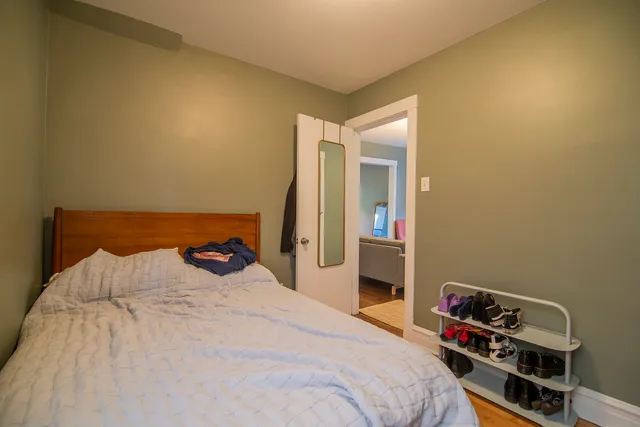 a kitchen with stainless steel appliances wooden floor and chairs in it