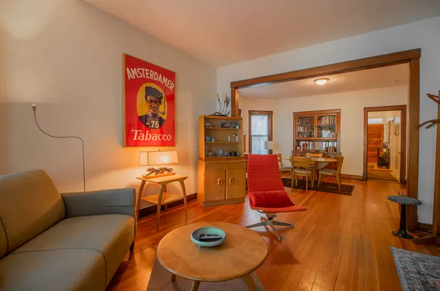 a living room with furniture and a dining table