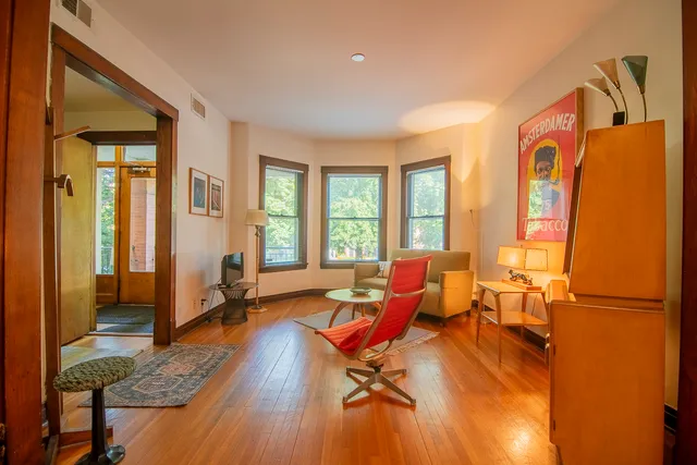 a living room with furniture and a book shelf