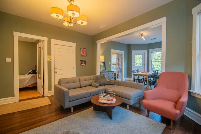 a kitchen with granite countertop stainless steel appliances a stove top oven and a refrigerator