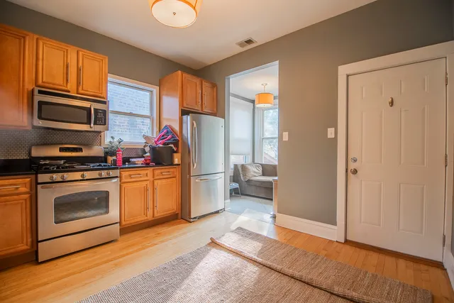a living room with furniture a flat screen tv and a window