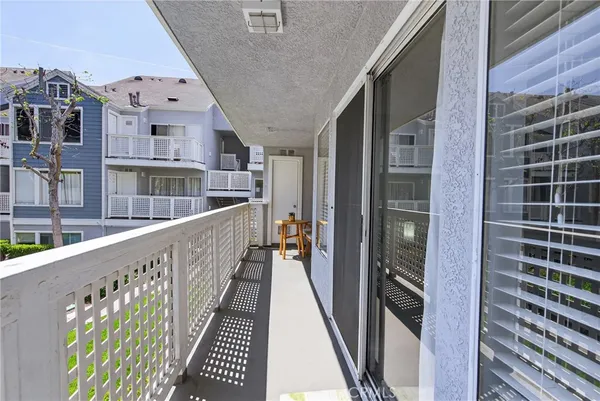 a balcony with table and chairs