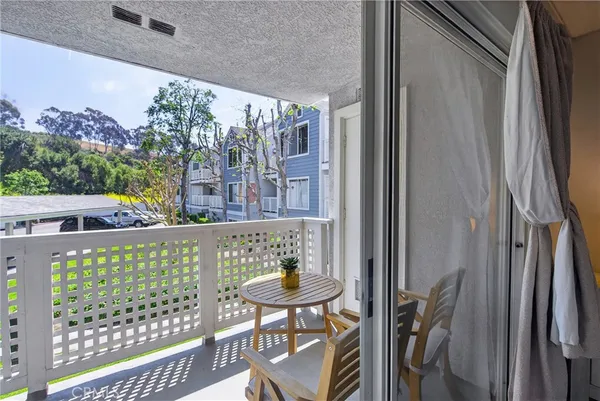 a view of balcony with wooden floor