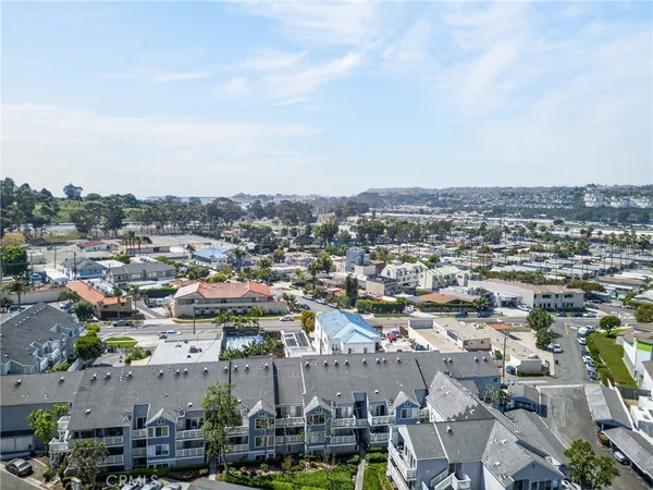 an aerial view of residential houses with outdoor space and swimming pool