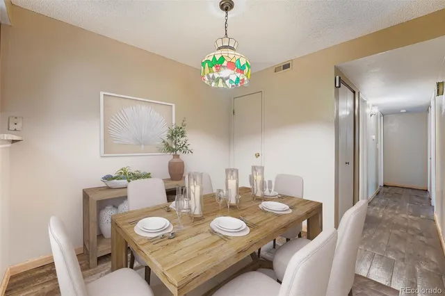 a view of a dining room with furniture and chandelier