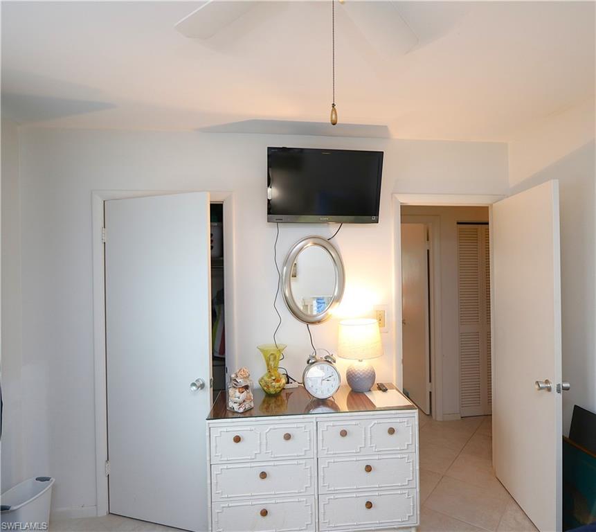 235 Seaview Court, Unit B5 Marco Island, FL 34145 - Photo 13 of 23 a room with fireplace and mirror