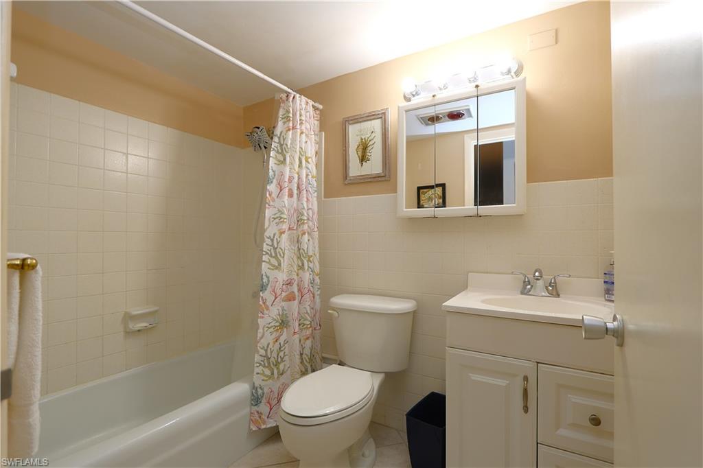 235 Seaview Court, Unit B5 Marco Island, FL 34145 - Photo 14 of 23 a bathroom with a sink a toilet and shower
