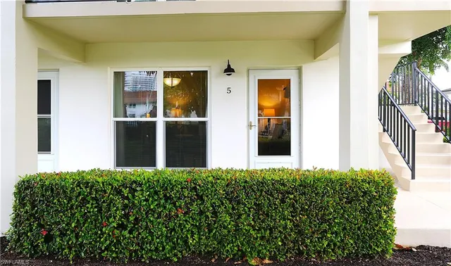 a view of a house with a flower garden