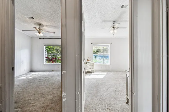 a view of a dining room with furniture and a chandelier