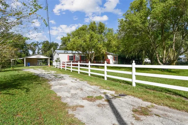 a view of a house with a big yard