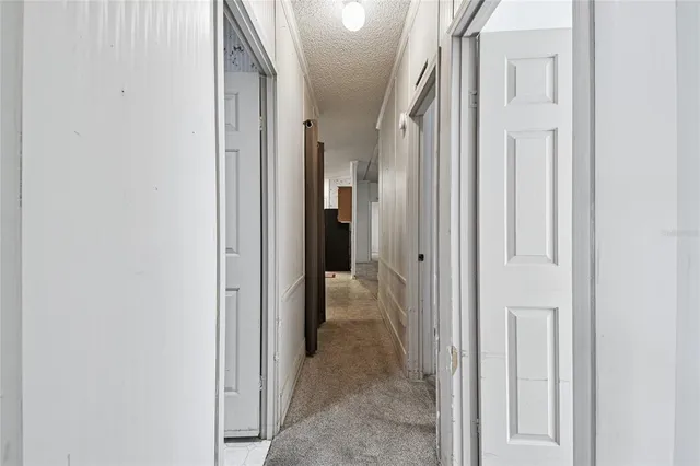 a living room with furniture a ceiling fan and a large window