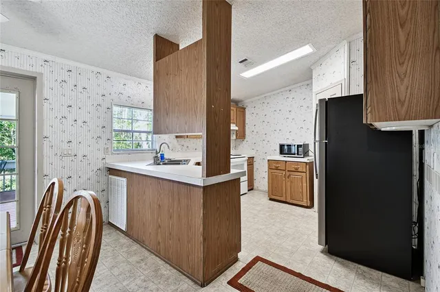 an aerial view of residential house with outdoor space and trees all around