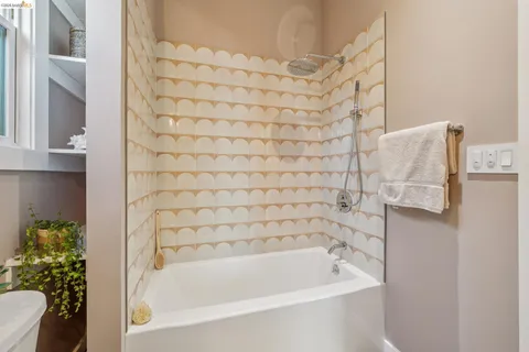 a bathroom with a bathtub and shower
