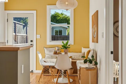 a view of a dining room with furniture and a window