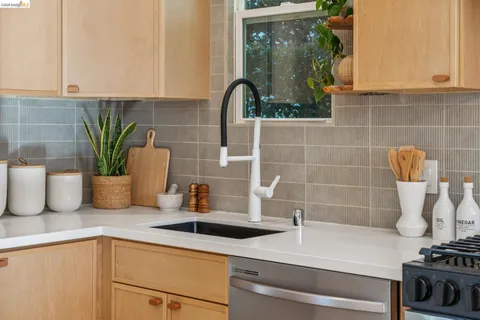 a bathroom with a potted plant on the counter and a white wooden cabinets