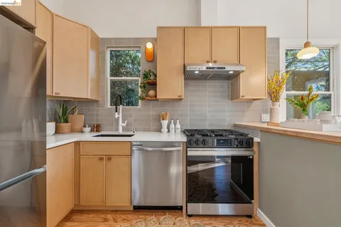 a kitchen with a stove a sink and a refrigerator