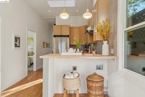 a kitchen with stainless steel appliances granite countertop a sink and a refrigerator