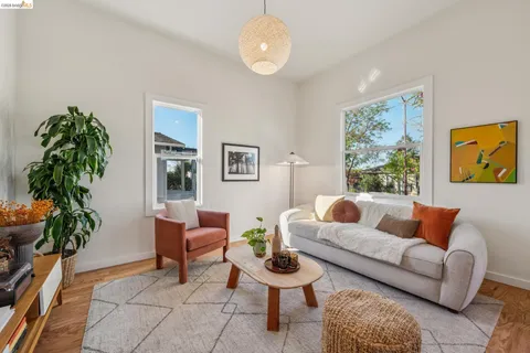 a living room with furniture a window and a potted plant