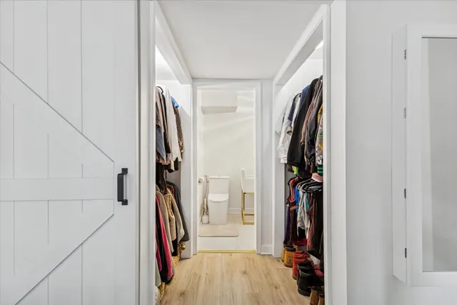 a view of walk in closet with clothes