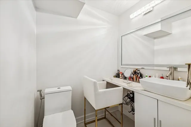a bathroom with a sink mirror and toilet