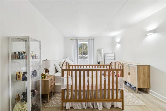 a view of a bedroom with wooden floor