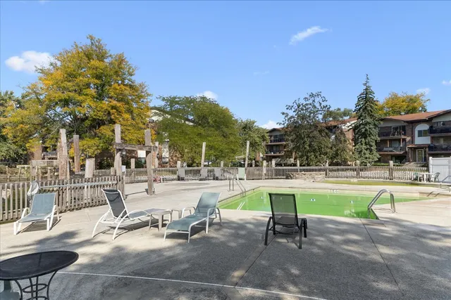 a swimming pool with outdoor seating and yard