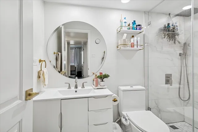 a bathroom with a toilet sink and mirror