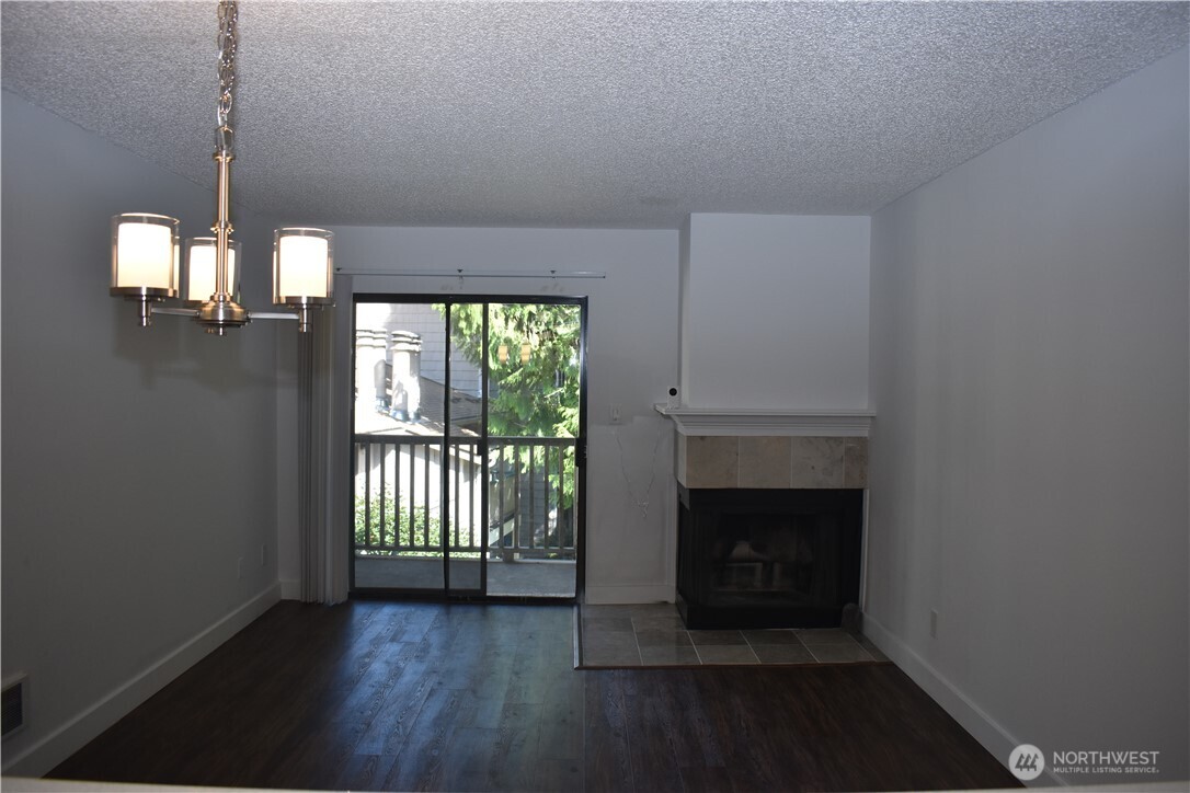 33025 18th Place South, Unit D301 Federal Way, WA 98003 - Photo 18 of 21 a view of a livingroom with a fireplace wooden floor and staircase