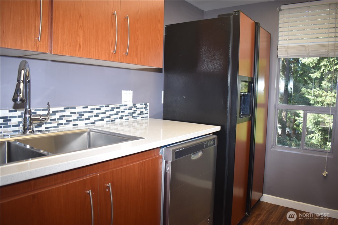33025 18th Place South, Unit D301 Federal Way, WA 98003 - Photo 4 of 21 a kitchen with a sink and a refrigerator