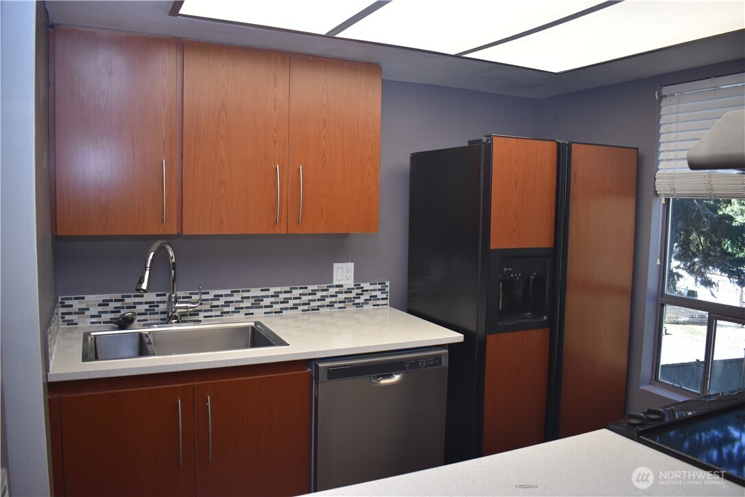 33025 18th Place South, Unit D301 Federal Way, WA 98003 - Photo 5 of 21 a kitchen with a sink a refrigerator and window