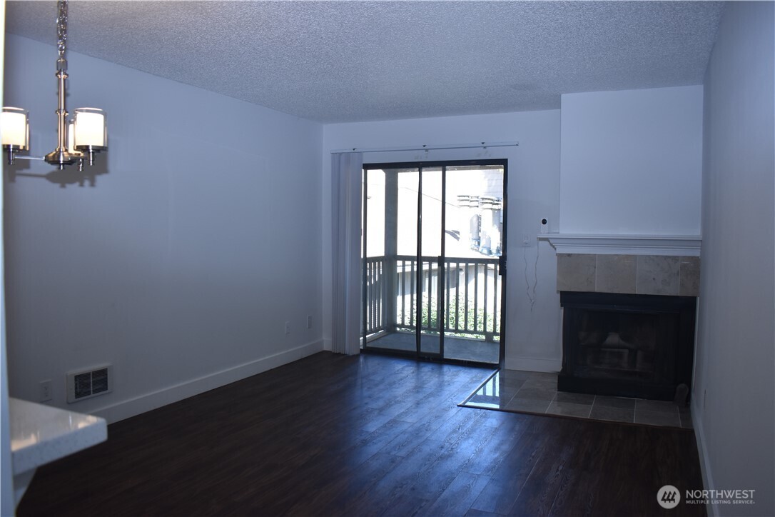 33025 18th Place South, Unit D301 Federal Way, WA 98003 - Photo 7 of 21 an empty room with wooden floor fireplace and windows