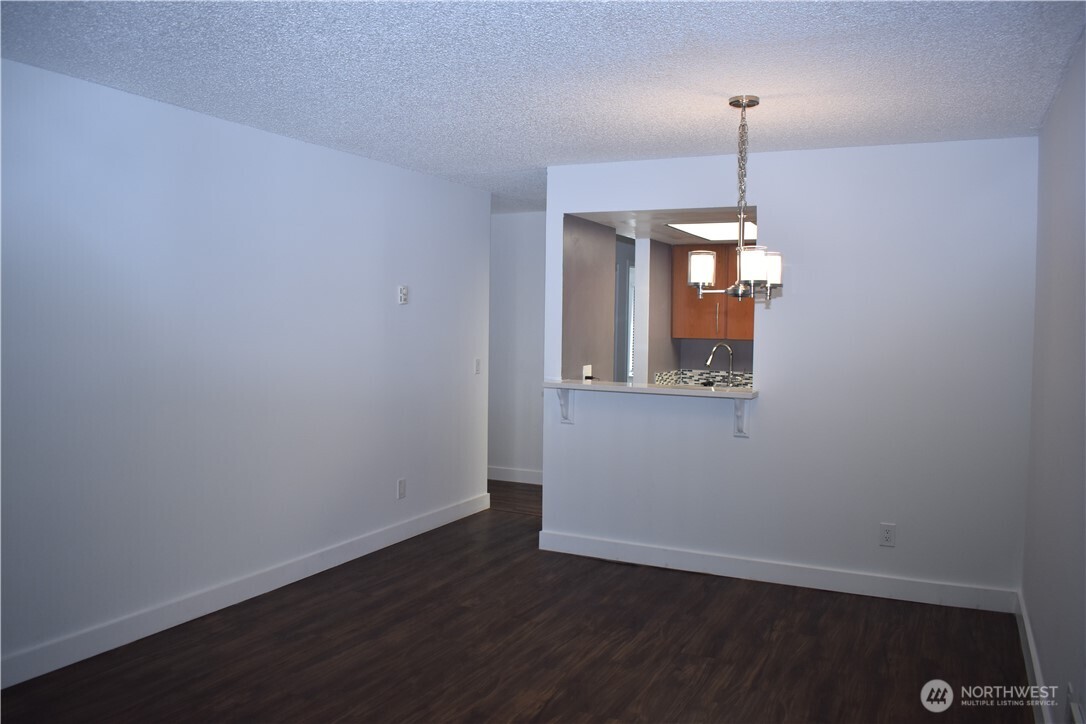 33025 18th Place South, Unit D301 Federal Way, WA 98003 - Photo 8 of 21 a view of an empty room with window and wooden floor