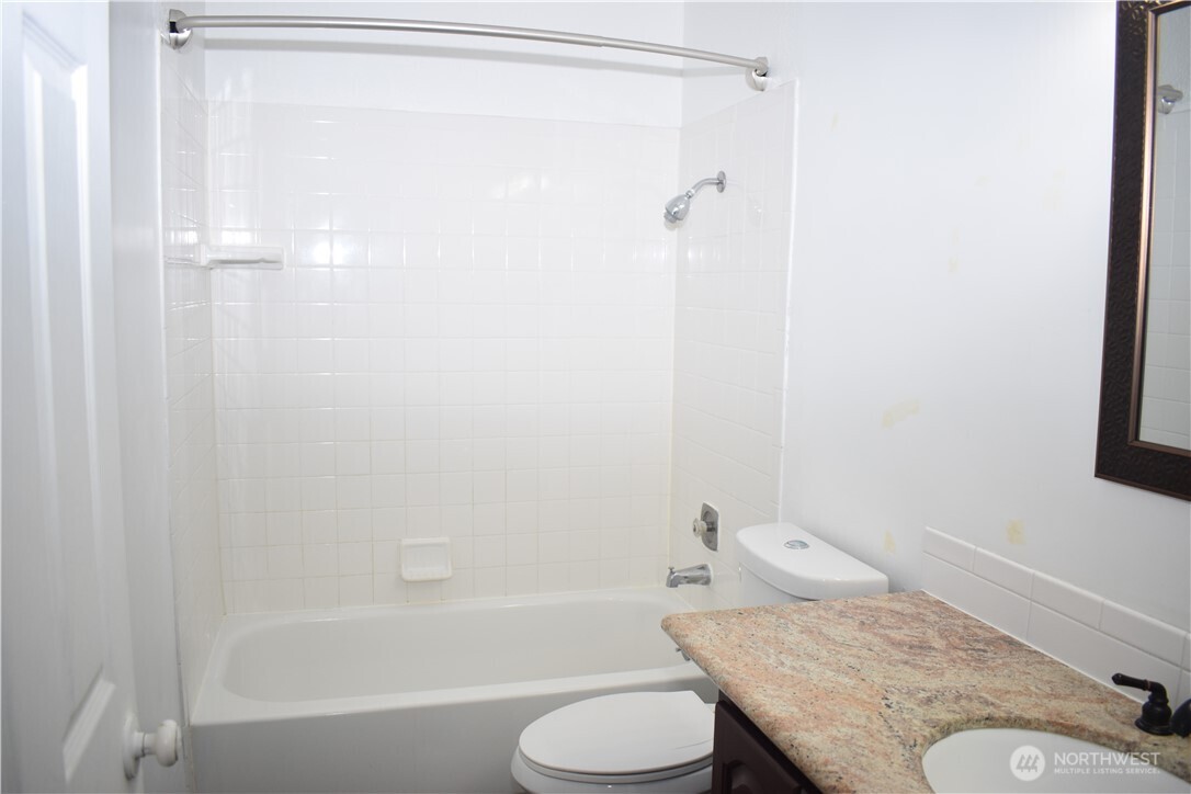 33025 18th Place South, Unit D301 Federal Way, WA 98003 - Photo 10 of 21 a bathroom with a granite countertop sink toilet and shower