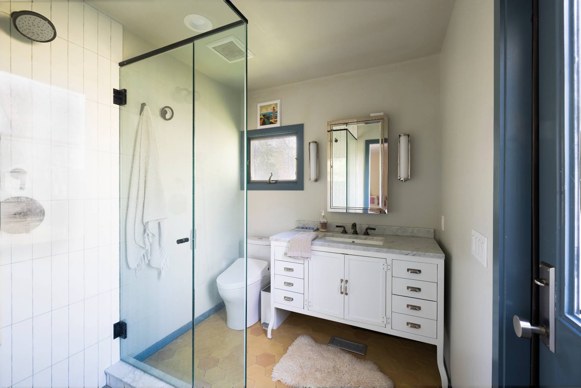 33 Robins Way East Hampton, NY 11937 - Photo 12 of 18 a bathroom with a granite countertop sink a mirror and shower
