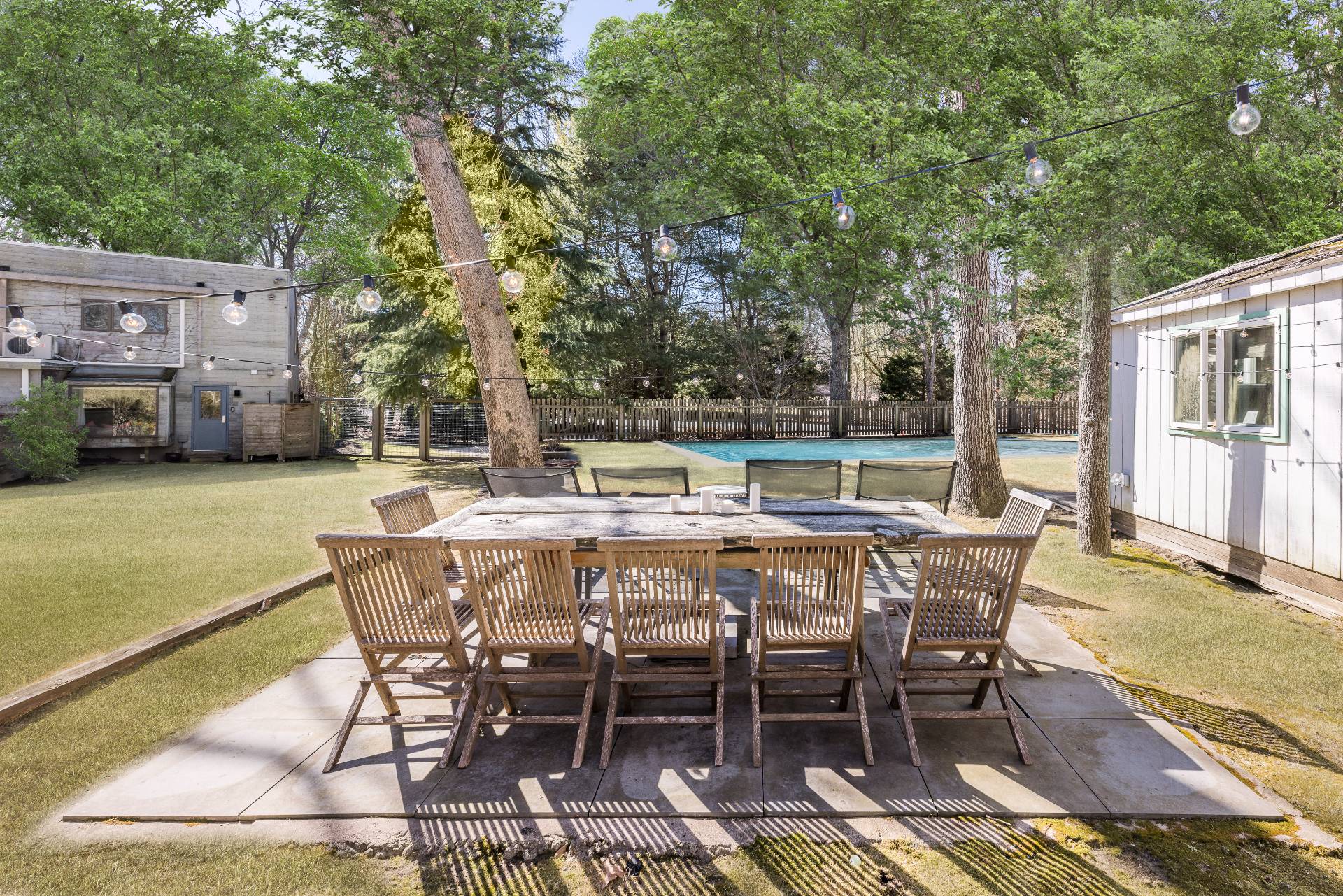 33 Robins Way East Hampton, NY 11937 - Photo 4 of 18 a view of a patio with table and chairs and floor to ceiling window
