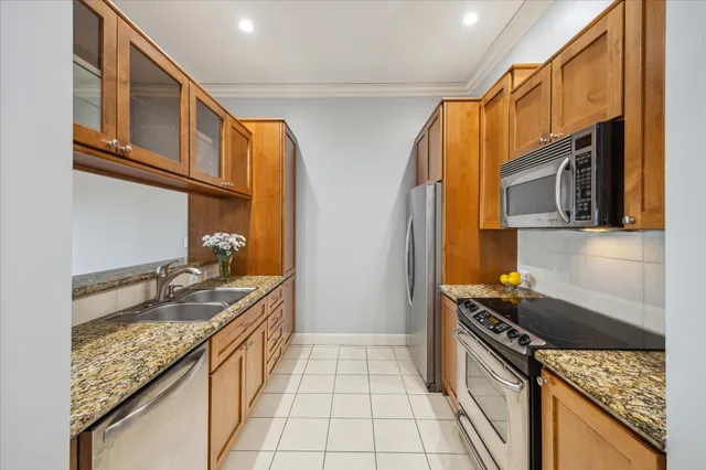 a kitchen with a sink stove top oven and cabinets