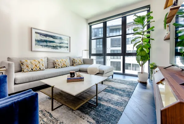 a living room with furniture and large window