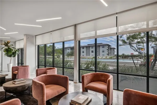 a living room with furniture and a floor to ceiling window