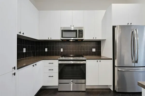 a kitchen with a stove and a refrigerator