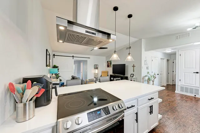 a kitchen with stainless steel appliances a refrigerator sink and stove