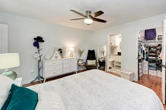 a bedroom with a bed furniture and wooden floor