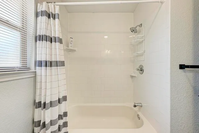 a bathroom with a sink a toilet a shower and a mirror