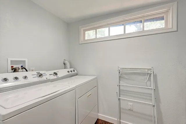 a view of a workspace with furniture and wooden floor